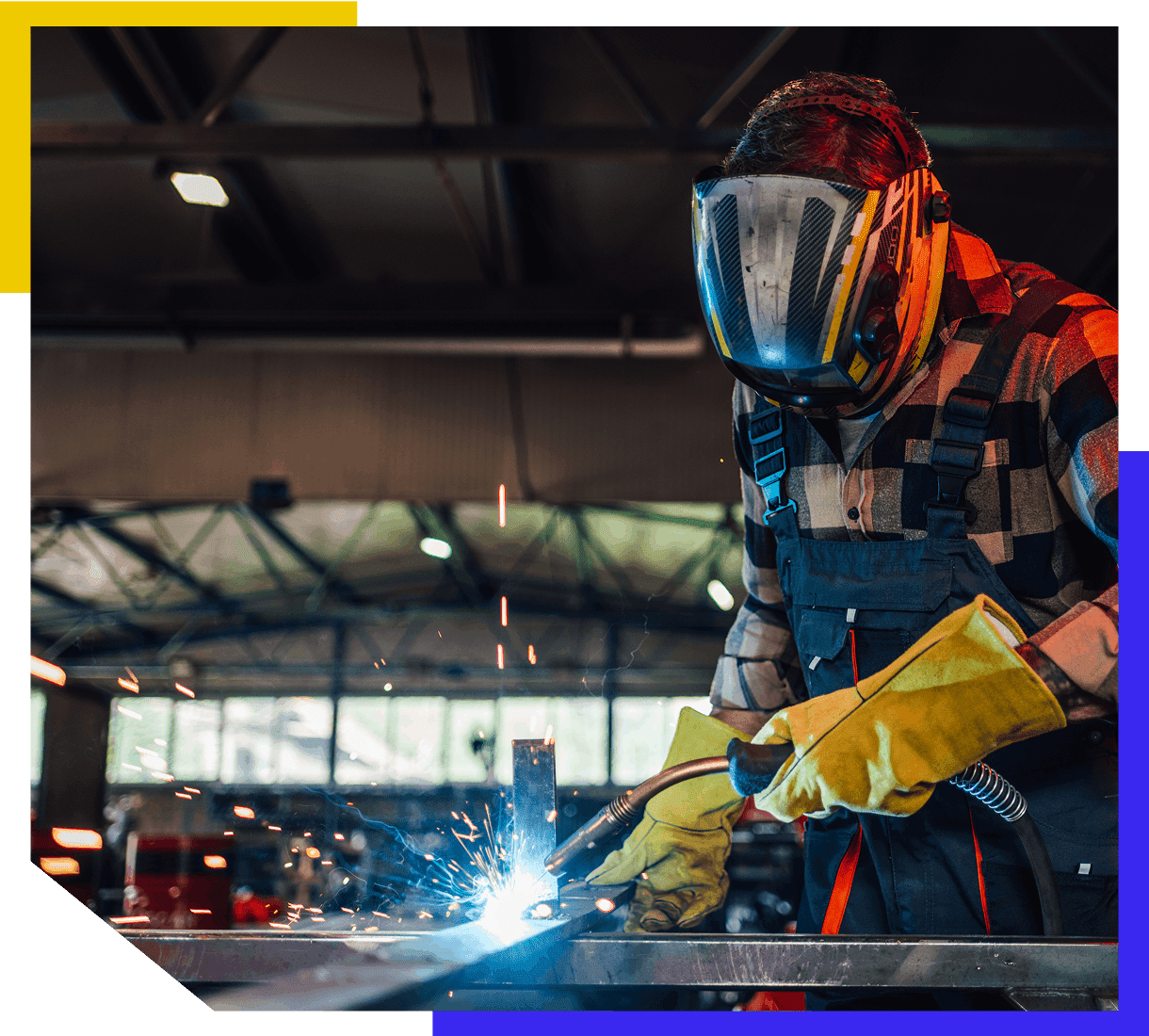 Welder working with protective gear and sparks.